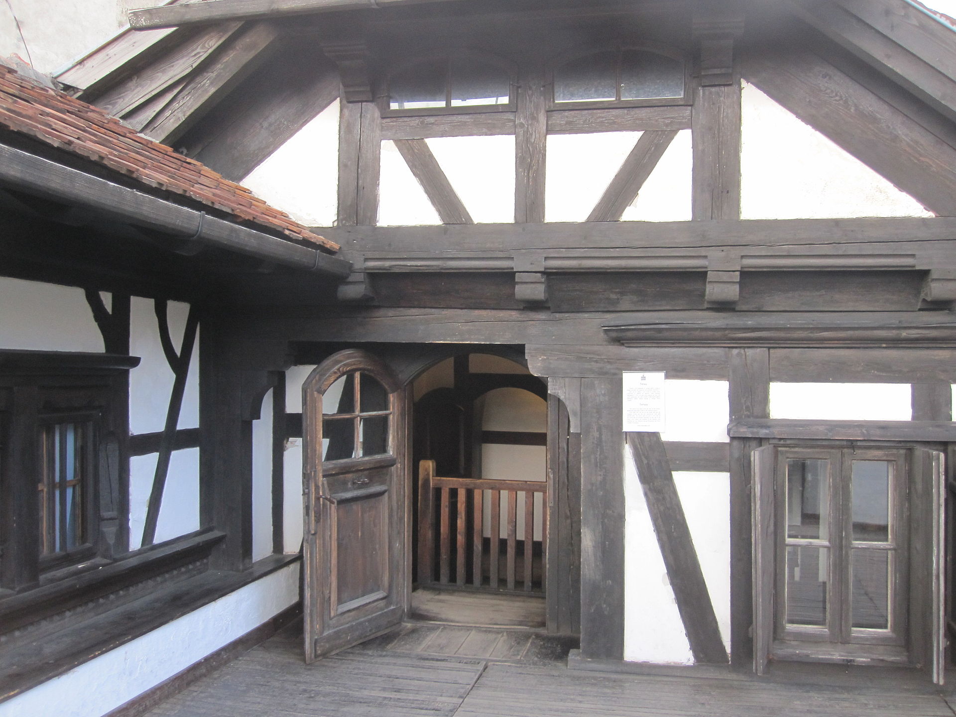 Veranda exterioară: stâlpi, contravântuiri, tâmplărie și parapet.