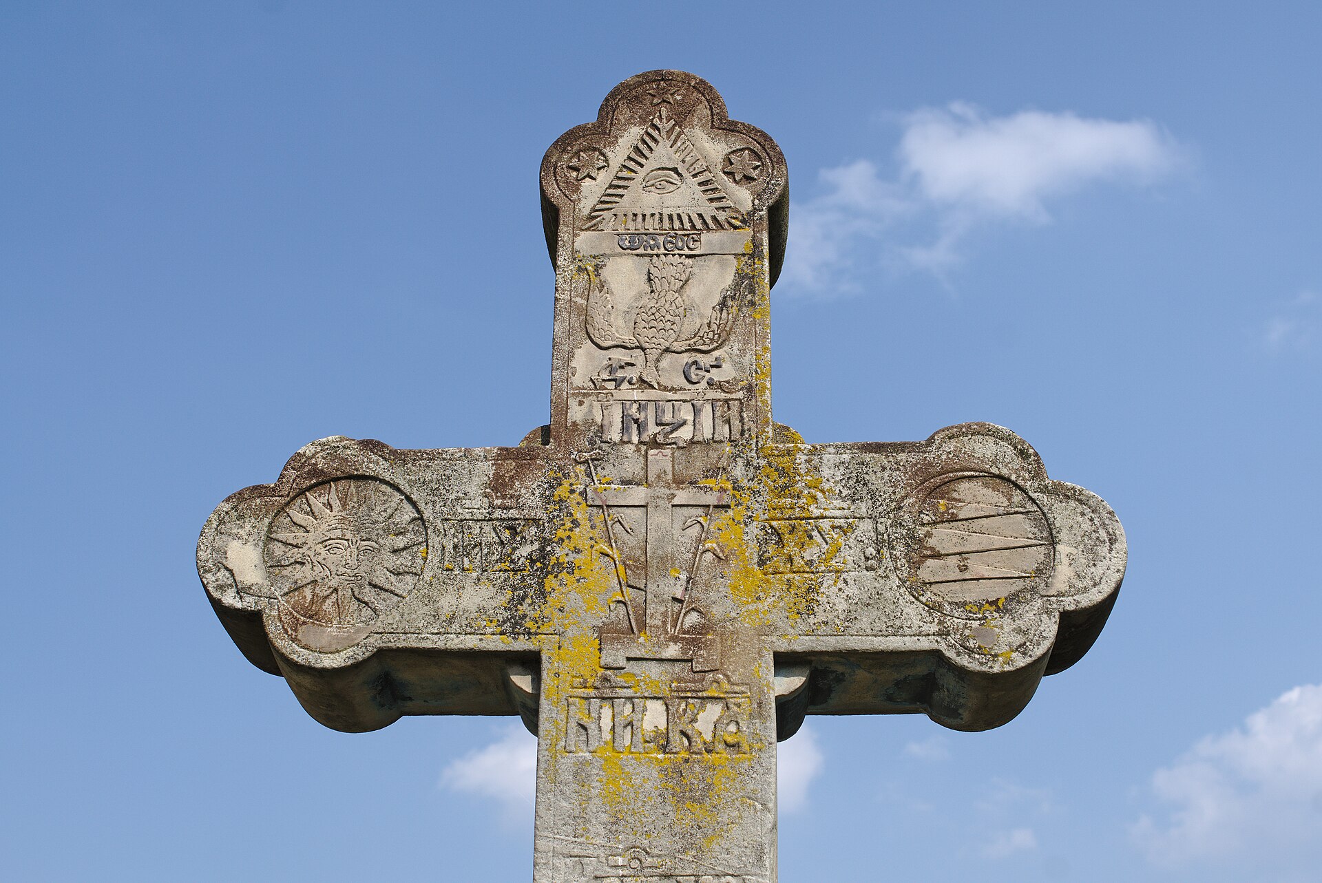 Detaliu frontal al reliefului și muchiilor crucii de piatră