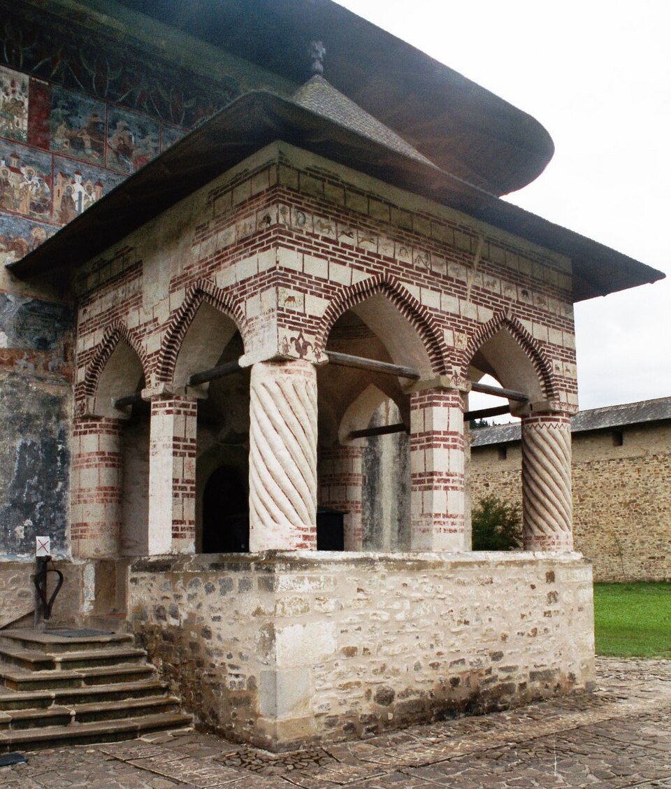 Pridvor cu arcade, coloane și trepte de acces, privit oblic de aproape