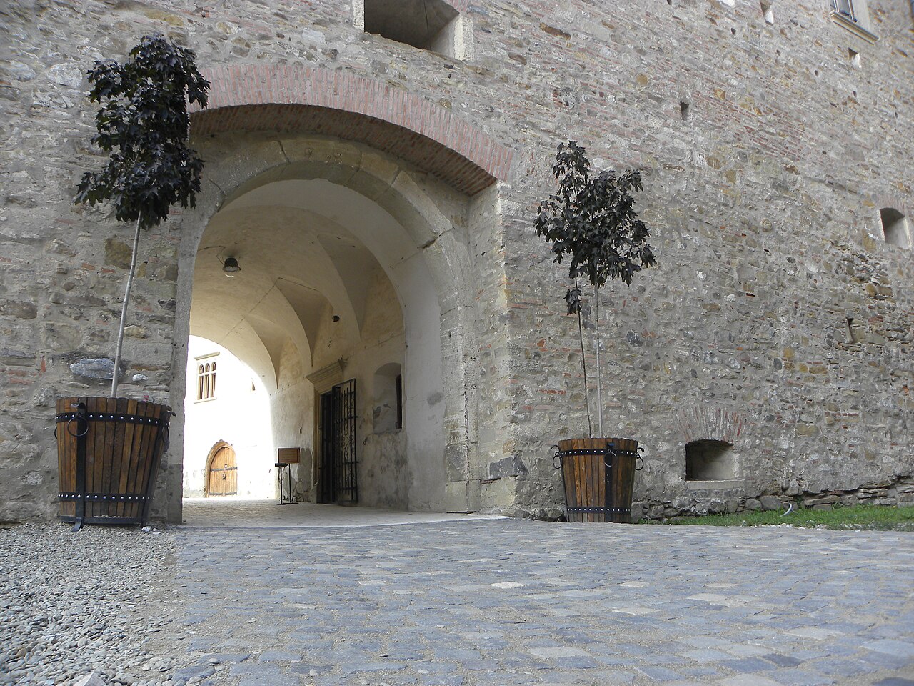 Portal interior arcuit, ușă și suprafață de zidărie a castelului
