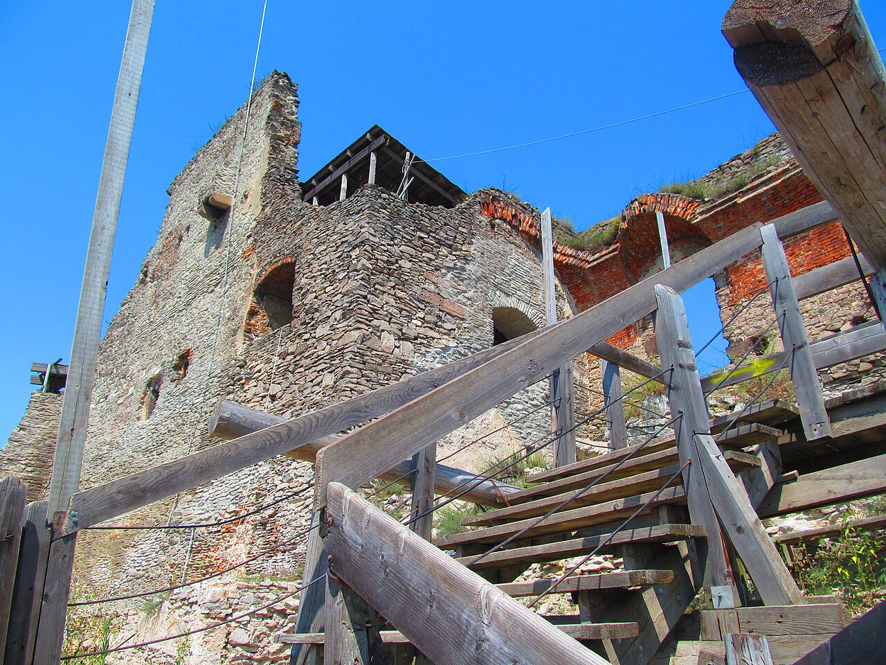Scară și balustradă de lemn către clădirile ruinate