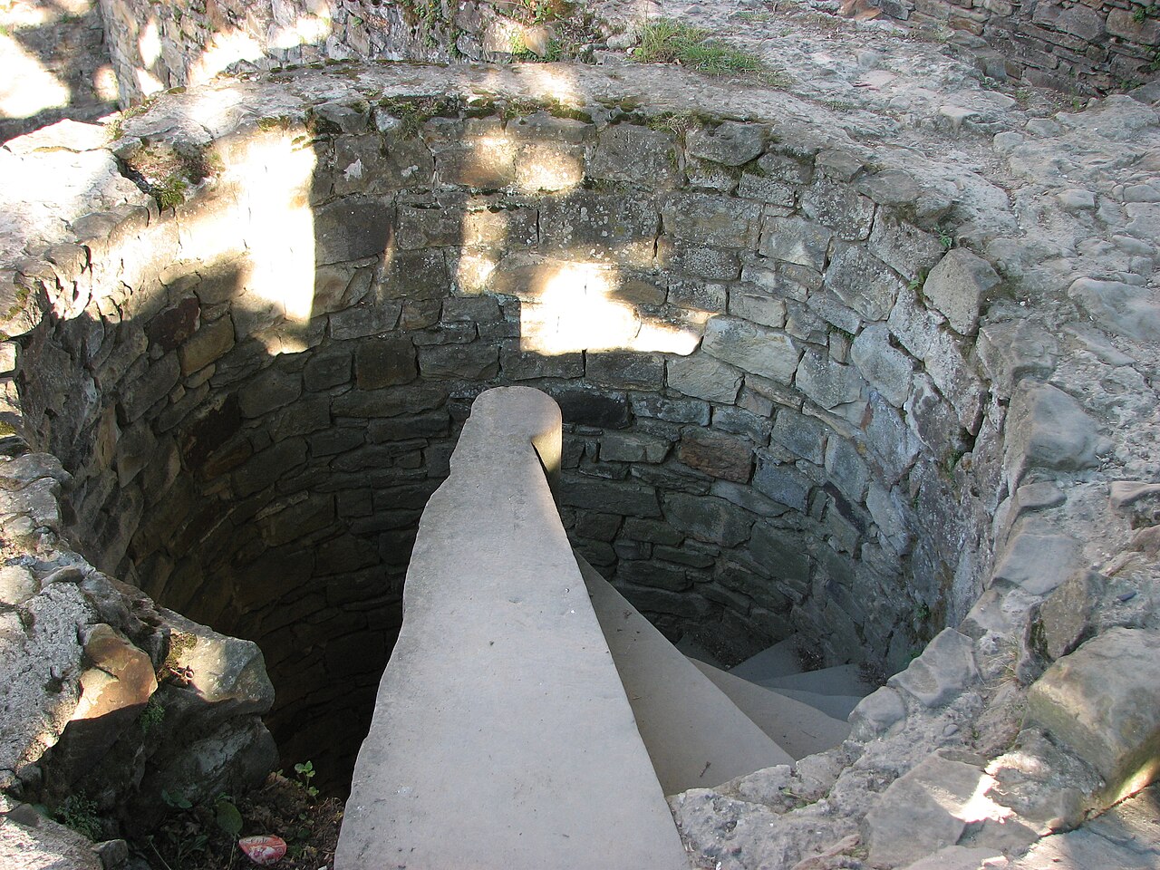 Scară în spirală și parapet de piatră privite de la nivelul superior