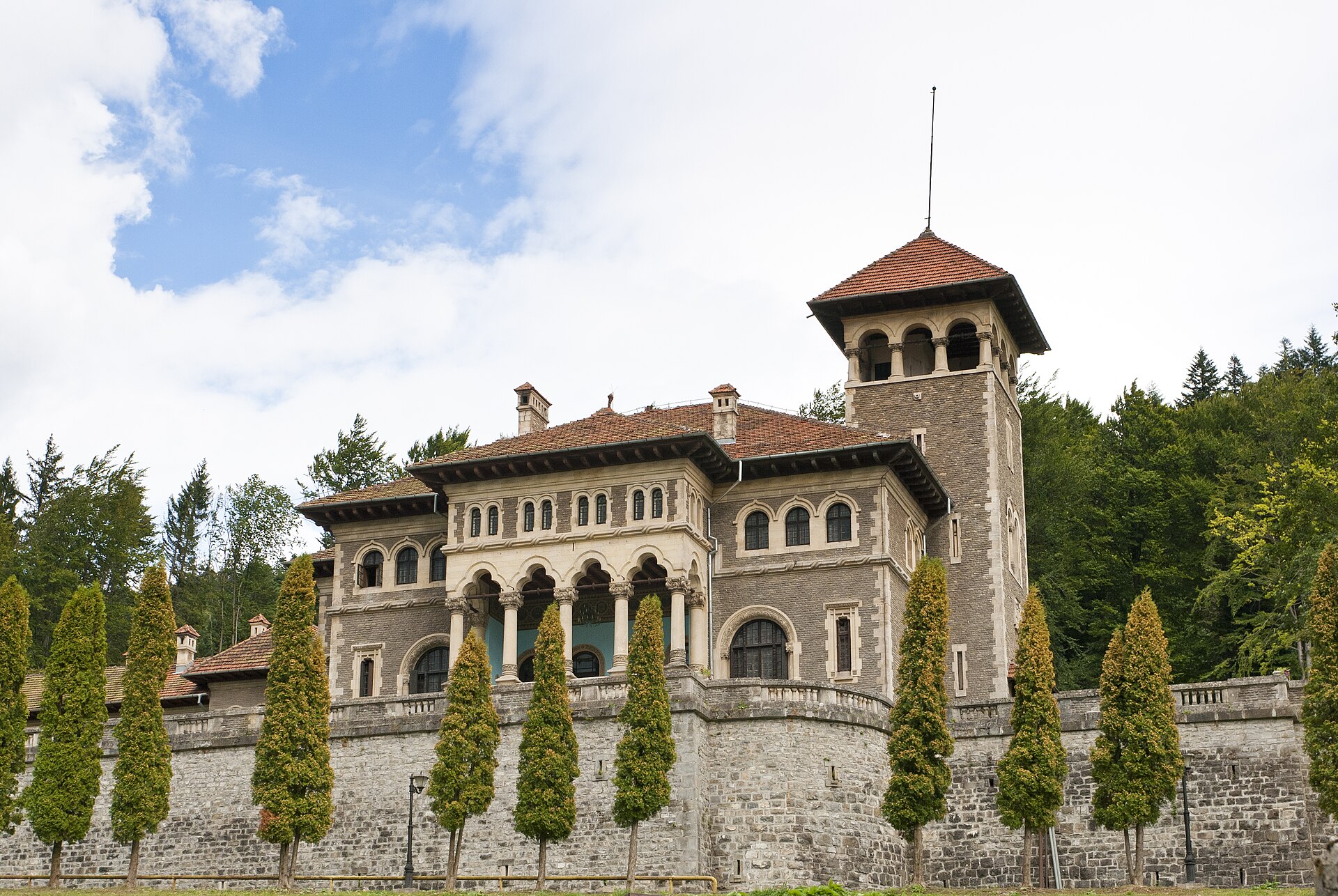 Fațada castelului către terasă: turn, arcade, balustrade și ziduri de sprijin