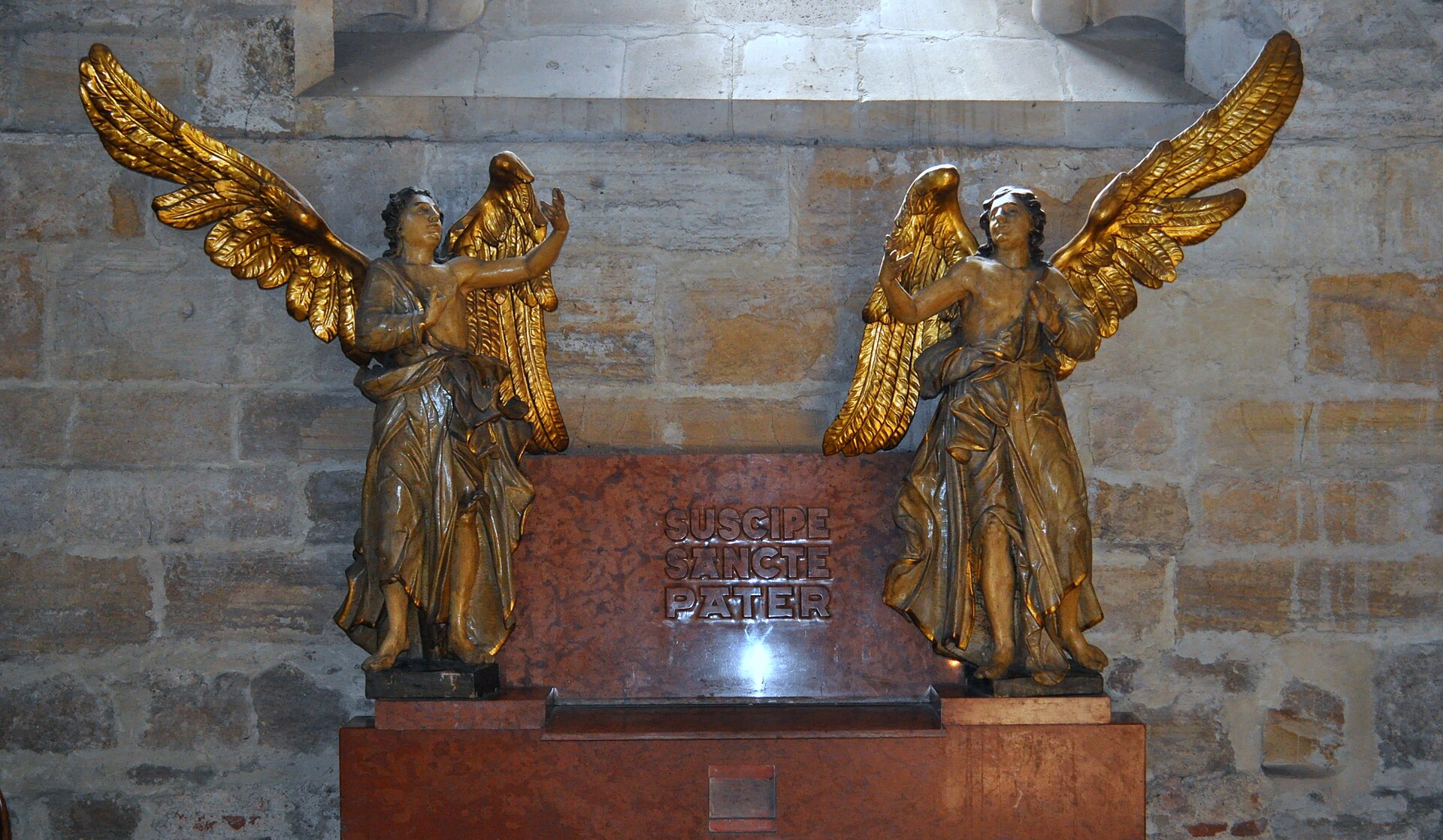 Monument funerar cu două figuri de îngeri și panou de inscripție.