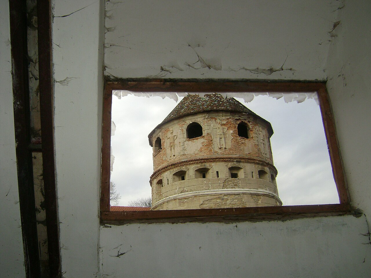 Turnul văzut prin fereastra unui corp al castelului.