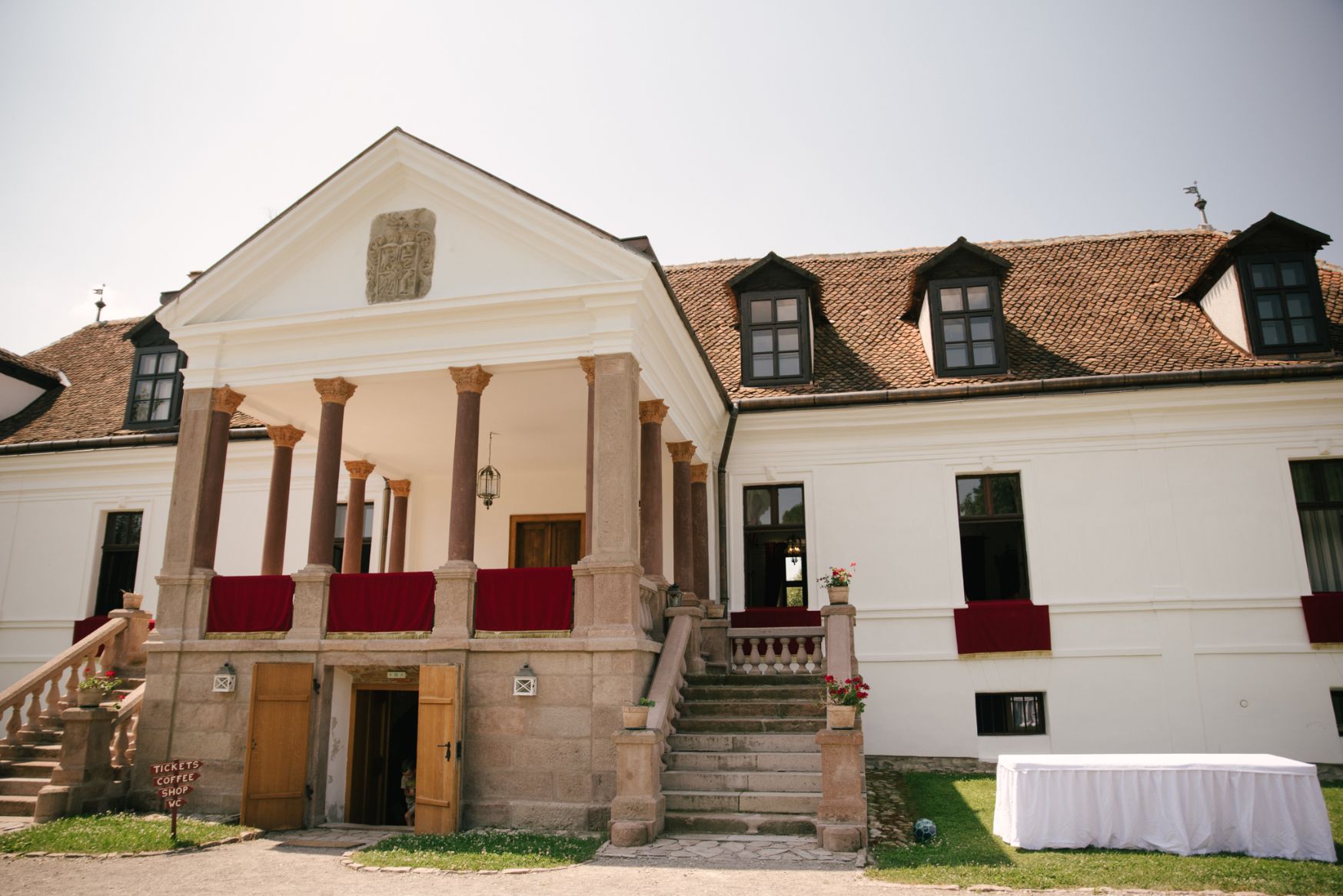 Porticul central, coloanele, scările duble și lucarnele.