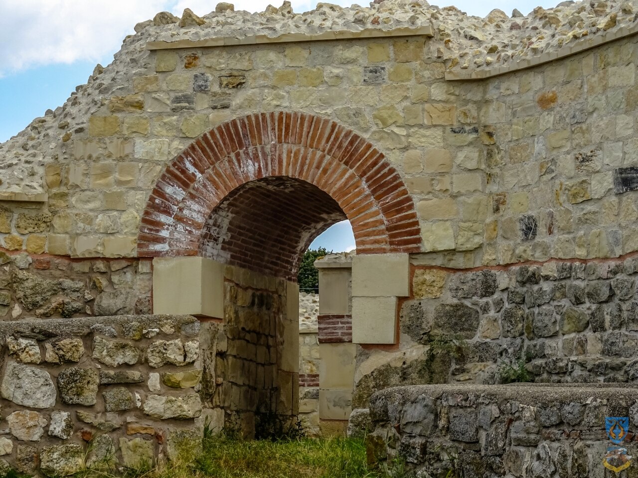 Poartă restaurată cu arc de cărămidă.