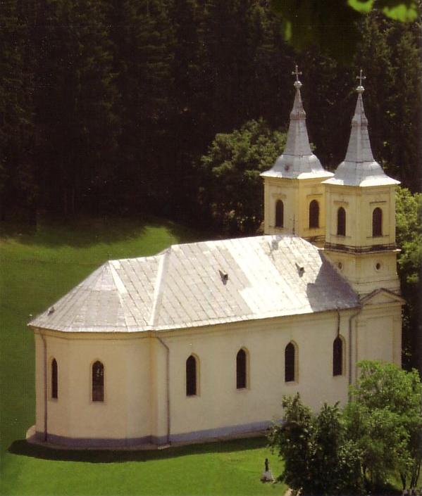 Biserica de zid din 1875–1879, cu cele două turnuri frontale; nu este biserica nouă.